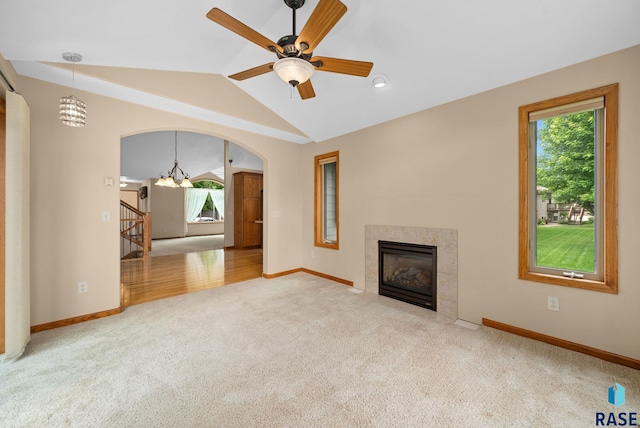 4912 E 42nd St, Sioux Falls, SD 57110 - unfurnished living room featuring a chandelier, carpet, a premium fireplace, vaulted ceiling, and ceiling fan