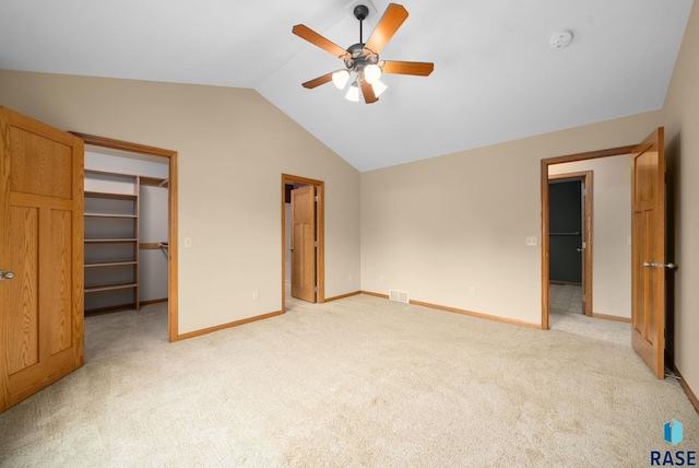 4912 E 42nd St, Sioux Falls, SD 57110 - unfurnished bedroom featuring lofted ceiling, a walk in closet, light colored carpet, a ceiling fan, and a closet