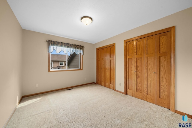 4912 E 42nd St, Sioux Falls, SD 57110 - unfurnished bedroom with multiple closets and carpet flooring