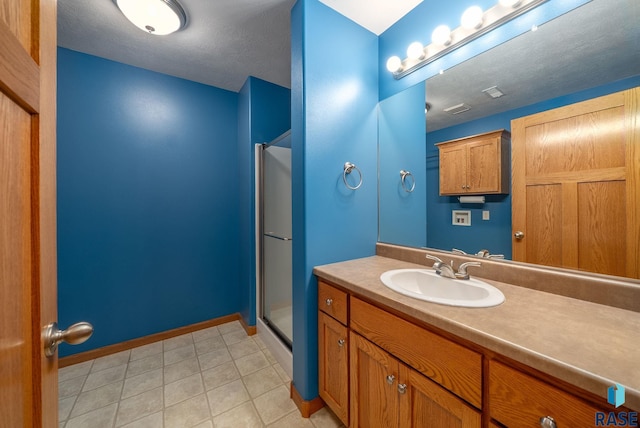 4912 E 42nd St, Sioux Falls, SD 57110 - full bathroom with vanity, a stall shower, and tile patterned flooring