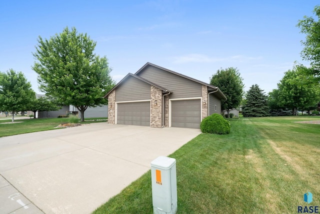 4912 E 42nd St, Sioux Falls, SD 57110 - view of side of home featuring concrete driveway, an attached garage, a yard, and brick siding