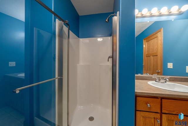 4912 E 42nd St, Sioux Falls, SD 57110 - bathroom with a stall shower, vanity, and a textured ceiling