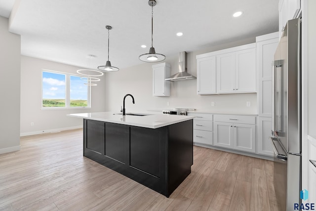 501 N Wildcat Dr, Sioux Falls, SD 57110 - kitchen with wall chimney exhaust hood, high end refrigerator, light wood-type flooring, light countertops, and white cabinets