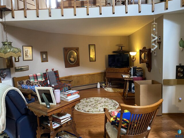 1496 121st St, Luverne, MN 56156 - living area with wood finished floors and a baseboard heating unit