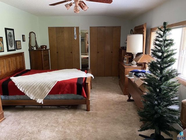 1496 121st St, Luverne, MN 56156 - carpeted bedroom with multiple closets, multiple windows, lofted ceiling, and ceiling fan