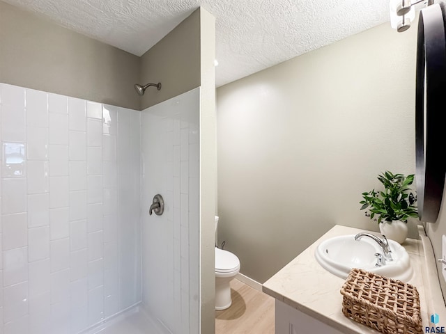 340 N Juniper Ave, Parker, SD 57053 - full bathroom with a tile shower, vanity, wood finished floors, and a textured ceiling