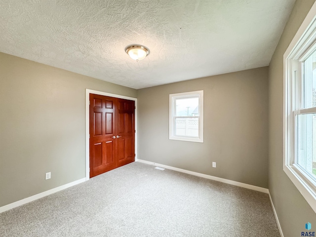 340 N Juniper Ave, Parker, SD 57053 - carpeted spare room featuring plenty of natural light and a textured ceiling