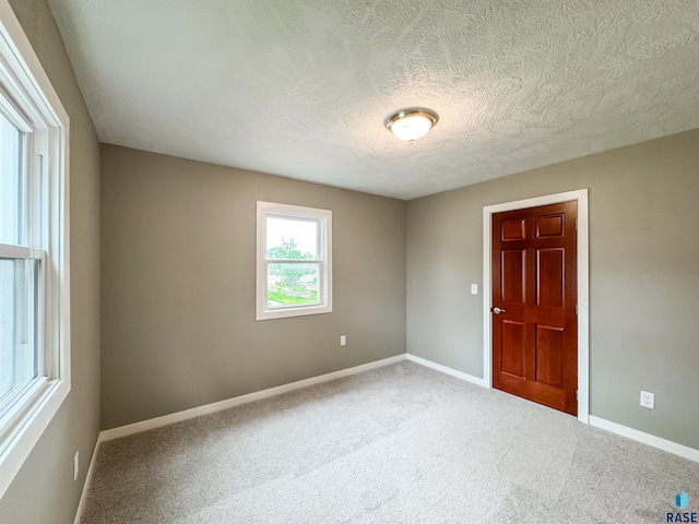 340 N Juniper Ave, Parker, SD 57053 - carpeted empty room with baseboards and a textured ceiling