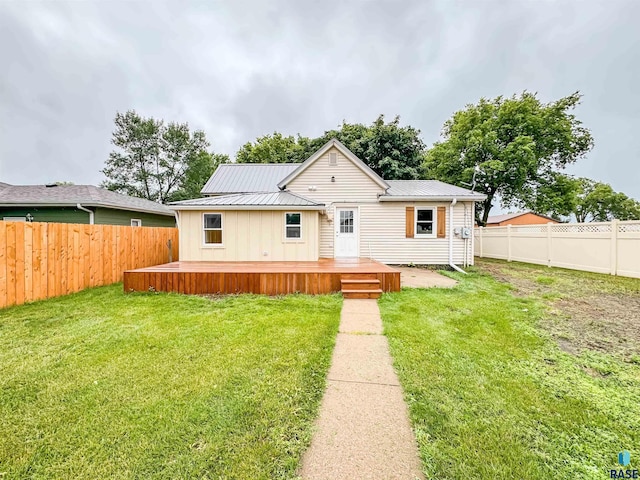 340 N Juniper Ave, Parker, SD 57053 - view of front of house featuring a fenced backyard, a metal roof, and a wooden deck