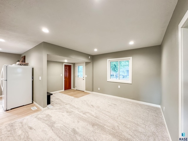 340 N Juniper Ave, Parker, SD 57053 - unfurnished living room featuring light colored carpet and recessed lighting