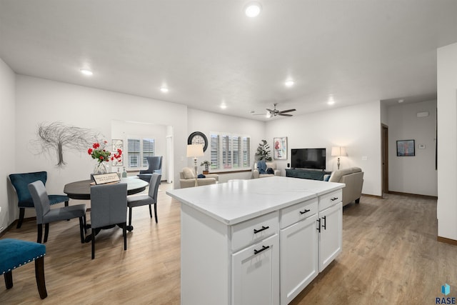 5402 S Bahnson Ave, Sioux Falls, SD 57108 - kitchen with open floor plan, recessed lighting, light wood finished floors, a center island, and white cabinetry