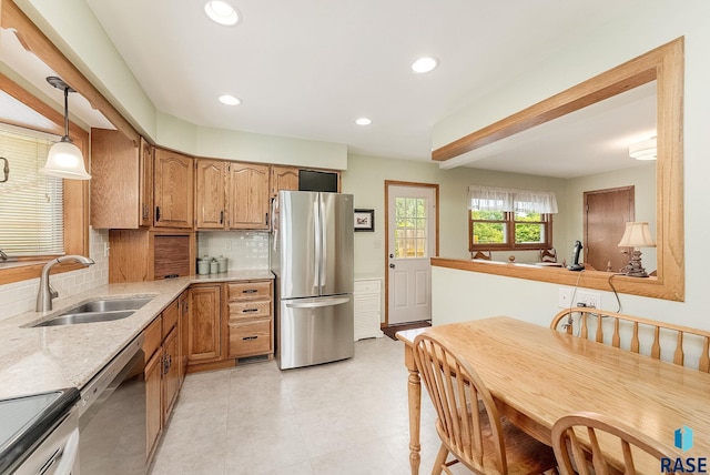 3112 E 15th St, Sioux Falls, SD 57103 - kitchen with stainless steel appliances, backsplash, recessed lighting, light stone countertops, and pendant lighting