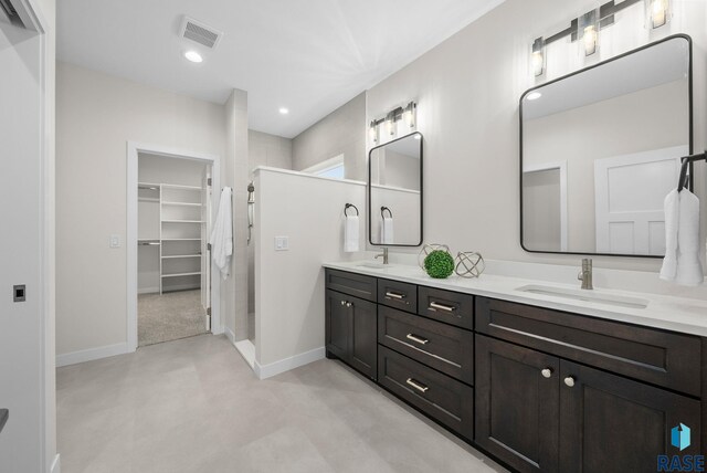 5601 E Morningside Cir, Sioux Falls, SD 57110 - full bath featuring a shower stall, double vanity, a spacious closet, and recessed lighting