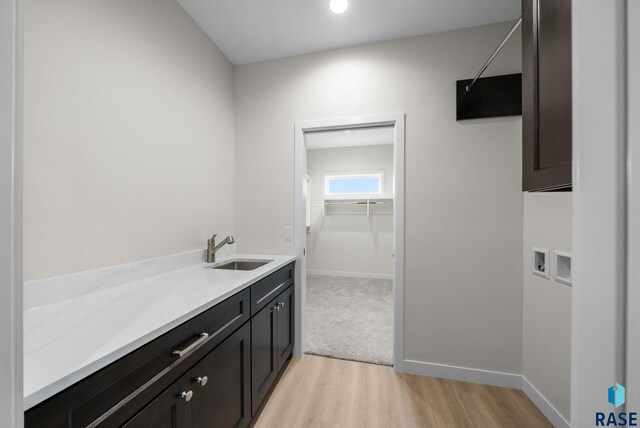 5601 E Morningside Cir, Sioux Falls, SD 57110 - bathroom featuring wood finished floors, vanity, and a spacious closet