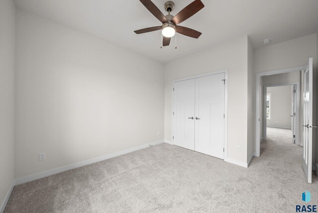5601 E Morningside Cir, Sioux Falls, SD 57110 - unfurnished bedroom with light carpet, a closet, and ceiling fan