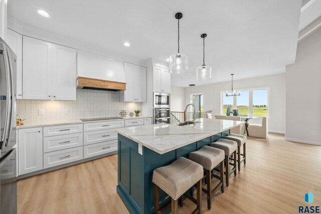 5601 E Morningside Cir, Sioux Falls, SD 57110 - kitchen with appliances with stainless steel finishes, light wood-style floors, white cabinets, and recessed lighting