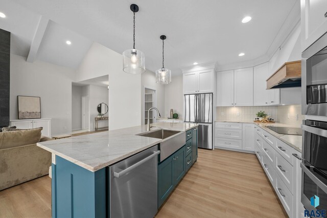 5601 E Morningside Cir, Sioux Falls, SD 57110 - kitchen with appliances with stainless steel finishes, white cabinets, backsplash, light wood finished floors, and open floor plan