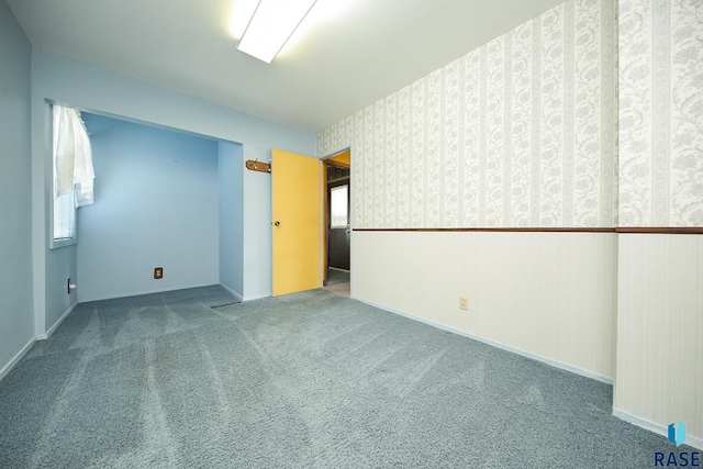 2312 E 19th St, Sioux Falls, SD 57103 - spare room with carpet floors and wallpapered walls