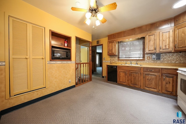 2312 E 19th St, Sioux Falls, SD 57103 - kitchen with black appliances, light colored carpet, light countertops, ceiling fan, and brown cabinets