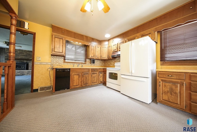 2312 E 19th St, Sioux Falls, SD 57103 - kitchen featuring white appliances, light carpet, ceiling fan, under cabinet range hood, and light countertops