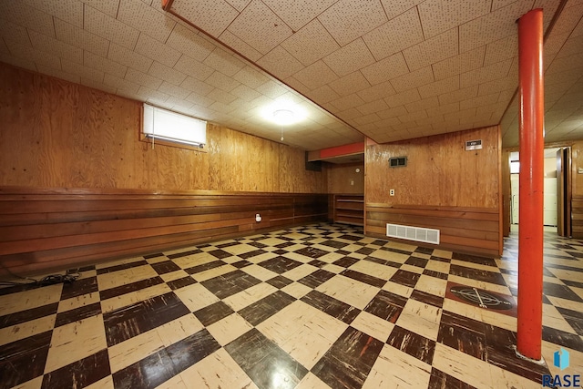 2312 E 19th St, Sioux Falls, SD 57103 - below grade area with wooden walls, tile patterned floors, and a paneled ceiling