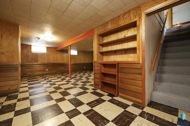 2312 E 19th St, Sioux Falls, SD 57103 - below grade area with tile patterned floors, stairs, and wood walls