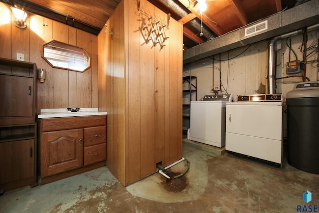 2312 E 19th St, Sioux Falls, SD 57103 - basement featuring separate washer and dryer, a water softener system, and wood walls