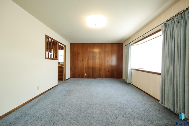 2312 E 19th St, Sioux Falls, SD 57103 - spare room featuring light colored carpet and wood walls
