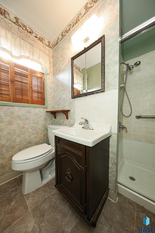 2312 E 19th St, Sioux Falls, SD 57103 - full bath featuring vanity, a stall shower, tile walls, and tile patterned floors