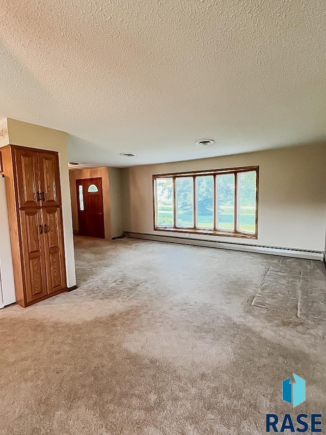 515 151st St, Luverne, MN 56156 - carpeted spare room with a textured ceiling and a baseboard radiator