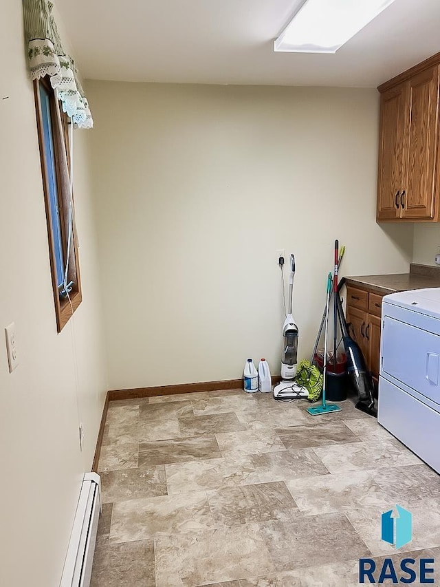 515 151st St, Luverne, MN 56156 - washroom featuring cabinet space, stone finish flooring, washer / clothes dryer, and baseboard heating