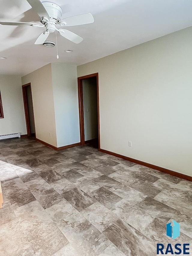 515 151st St, Luverne, MN 56156 - empty room with a ceiling fan, a baseboard radiator, and stone finish flooring