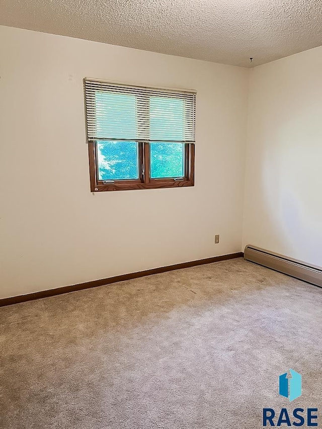 515 151st St, Luverne, MN 56156 - carpeted spare room with a baseboard heating unit and a textured ceiling