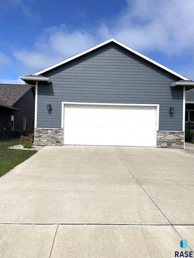 2405 N Main Ave, Tea, SD 57064 - view of front facade featuring stone siding, driveway, and an attached garage