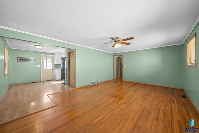 1615 E 32nd St, Sioux Falls, SD 57105 - spare room featuring crown molding, a ceiling fan, and wood finished floors