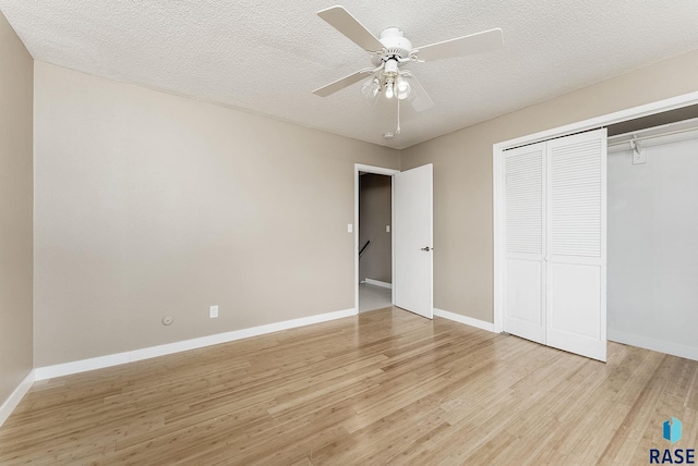 1811 S Marday Ave, Sioux Falls, SD 57103 - unfurnished bedroom with light wood-style flooring, a closet, ceiling fan, and a textured ceiling