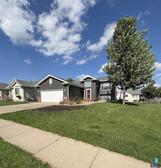 5312 S Leinster Ave, Sioux Falls, SD 57106 - view of front facade with a garage, a front yard, driveway, and brick siding