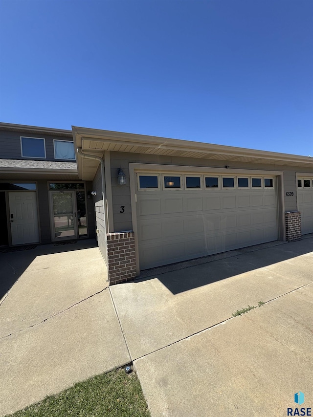 6509 S Tomar Rd Unit 3, Sioux Falls, SD 57108 - view of front of property featuring brick siding and a garage