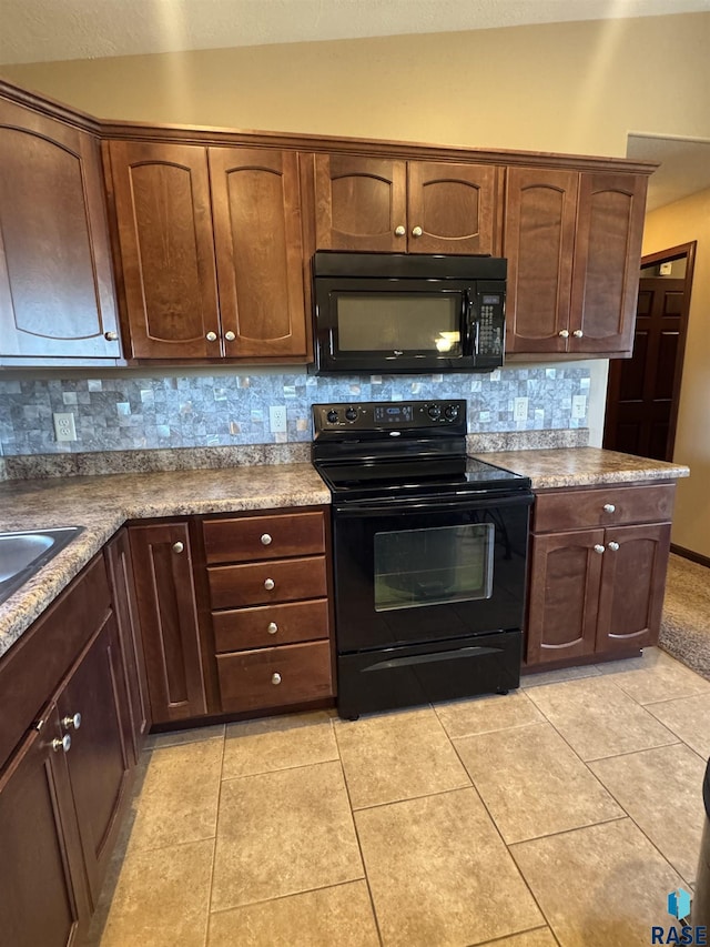 6509 S Tomar Rd Unit 3, Sioux Falls, SD 57108 - kitchen featuring black appliances, backsplash, light tile patterned floors, and lofted ceiling