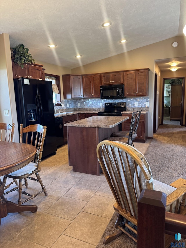 6509 S Tomar Rd Unit 3, Sioux Falls, SD 57108 - kitchen featuring black appliances, a kitchen island, backsplash, light tile patterned floors, and recessed lighting
