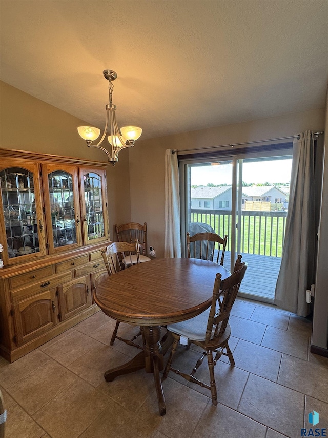 6509 S Tomar Rd Unit 3, Sioux Falls, SD 57108 - dining area featuring a chandelier, light tile patterned floors, and a textured ceiling