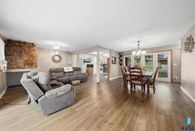 121 S 5th Ave, Brandon, SD 57005 - living room featuring a chandelier, wood finished floors, and a barn door
