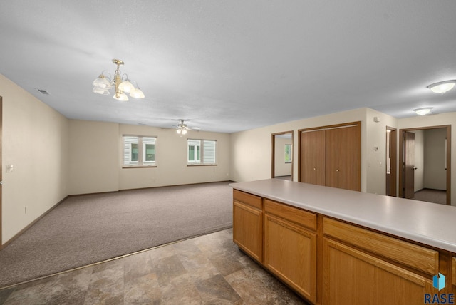 1418 E Redwood Blvd, Brandon, SD 57005 - kitchen featuring light carpet, a chandelier, ceiling fan, open floor plan, and light countertops