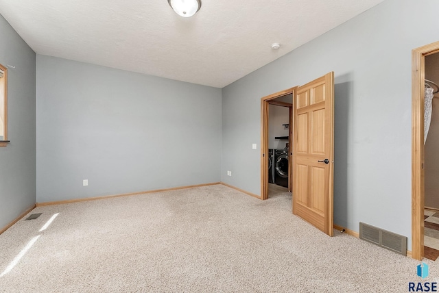 635 E Brian St, Tea, SD 57064 - unfurnished bedroom featuring washer / clothes dryer, light carpet, a walk in closet, and a closet