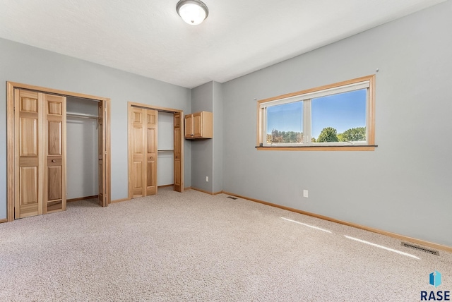 635 E Brian St, Tea, SD 57064 - unfurnished bedroom with multiple closets and light carpet