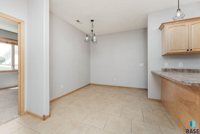 635 E Brian St, Tea, SD 57064 - unfurnished dining area featuring light tile patterned floors and baseboards
