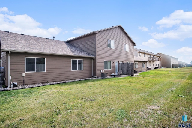 3604 W 93rd St, Sioux Falls, SD 57108 - rear view of house with a yard and roof with shingles
