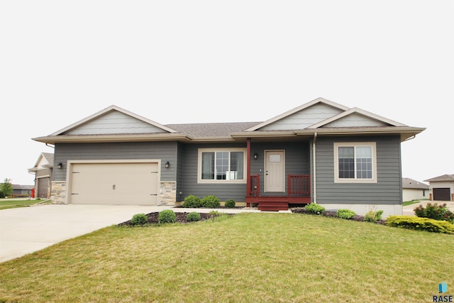 9500 W Richie Cir, Sioux Falls, SD 57106 - view of front of home with driveway, a front yard, an attached garage, and a porch