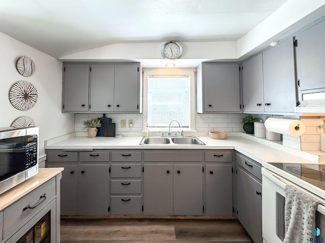 918 W 5th St, Sioux Falls, SD 57104 - kitchen with gray cabinets, stainless steel microwave, and lofted ceiling