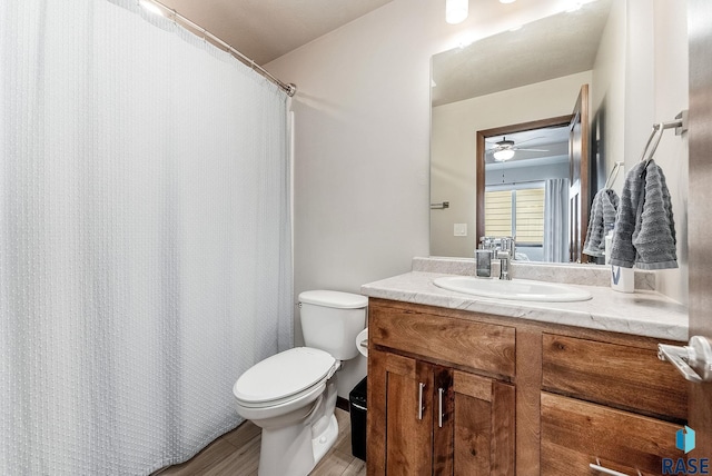 9400 W Colton St, Sioux Falls, SD 57106 - full bath featuring vanity, wood finished floors, ceiling fan, and a shower with shower curtain